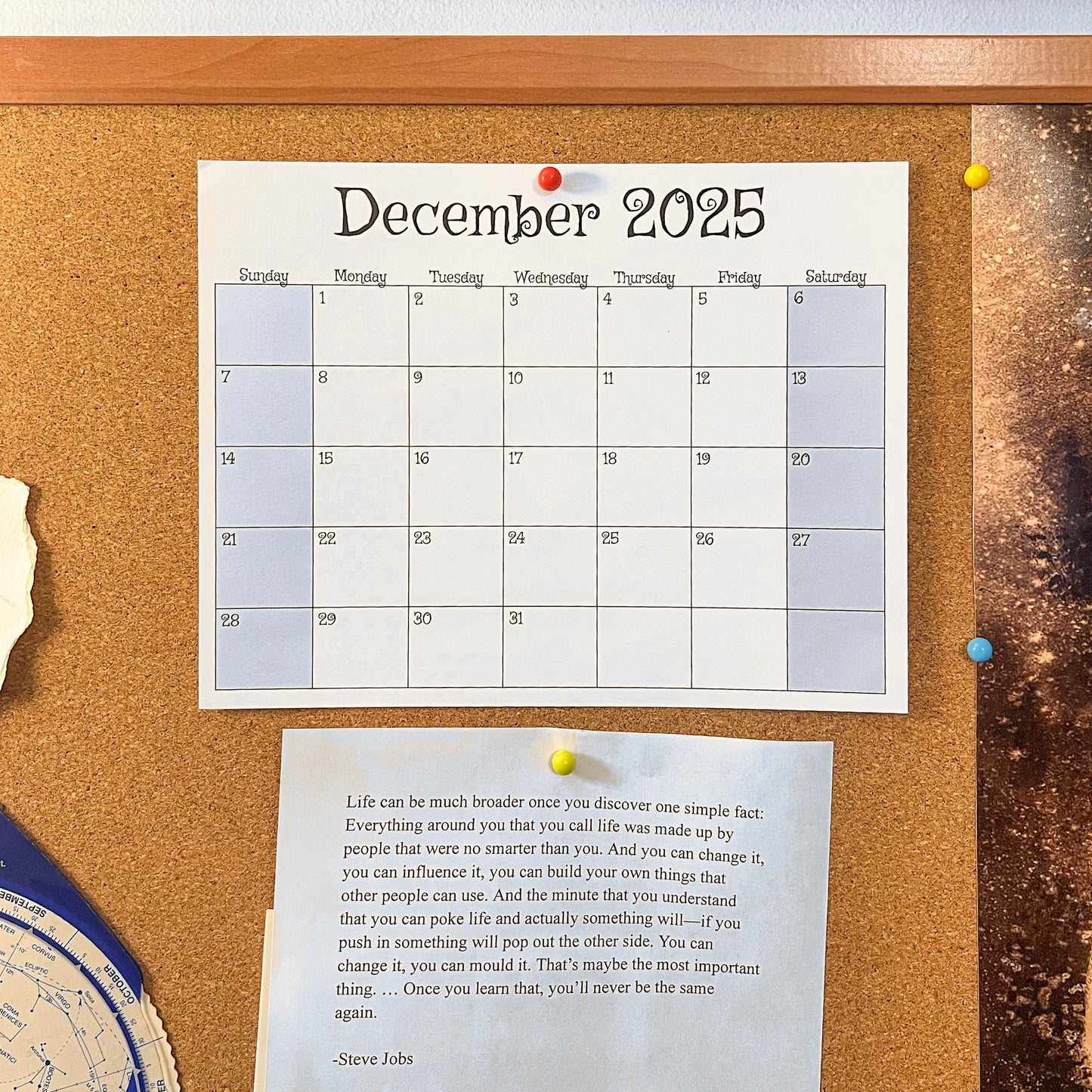 Calendar for December 2025 pinned to a cork bulletin board with a quote below.