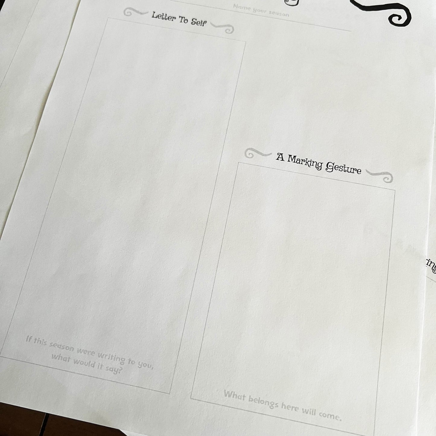 Sheet of paper with printed text and decorative elements on a wooden surface.